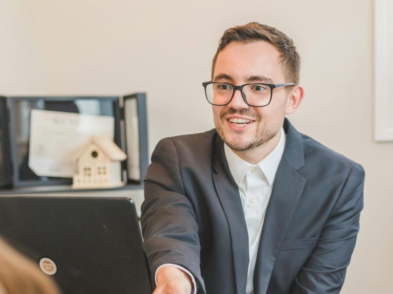 Man in Black Suit Jacket Wearing Eyeglasses