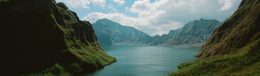 Photography of Mountains Near Body of Water